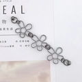 Detail of hollow flower metal chain in gunmetal finish on a minimalist magazine layout - Hollow Flower Bracelet (K497-Matte Gun Black)