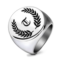 Close-up of a men's silver signet ring with gothic letter E and laurel wreath engraving - Letter T