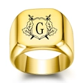 Macro detail of 18K gold signet ring with engraved heraldic shield and letter G emblem - Letter G