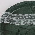 White delicate lace trim ribbon with geometric floral patterns on a dark green surface - 09w45mm
