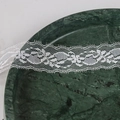 White floral lace ribbon with wavy edges on a dark marble base for DIY crafts - 12w35mm