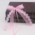 Nœud en organza rose avec bordure cœur sur livres anciens pour décor de mariage - Style Cœur en Organza / Rose