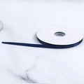 Navy blue polyester satin ribbon roll on marble background for gift wrapping - Dark Blue