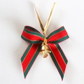 Christmas bow decoration with red and green stripes and a small golden bell - Striped Green Red Christmas Bow