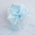 Macro detail of light blue pearlescent organza ribbon roll with shimmering glitter finish - 4cm Wide / Blue