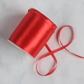 Single roll of high-quality red satin ribbon on a white spool for wedding gift wrapping - 0.3cm x 790m