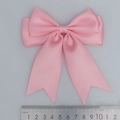 Pink double-layered polyester satin bow with dovetail ribbons shown next to a metal ruler - Light Pink (151#)