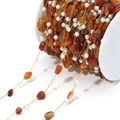 DIY bead chain with irregular orange natural stones and white pearls on golden spool - Amber
