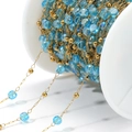 DIY golden bead chain with sky blue faceted crystal beads wound on a white spool - Lake Blue