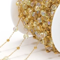 DIY colorful crystal bead chain with gold metal spacers on a white plastic spool - Clear Iridescent