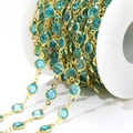 Bulk 6.6mm gold stainless steel chain with round light blue glass gems on white spool - Blue