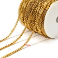 4mm gold plated stainless steel box chain with decorative beads on a white spool - Gold