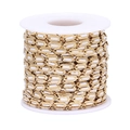 Macro shot of gold-plated Cuban link chain roll with white enamel inlay for DIY jewelry - White