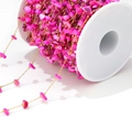 Detail of rose red stone bead chain with gold metal links on a white plastic spool - 1mm Gold Chain / Purple Red Shell Link