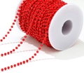 Macro shot of red faceted crystal beads on golden chain roll for DIY jewelry making - Red