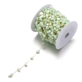 Detailed macro view of 7mm green shell pieces and gold wire chain on a white spool - Light Green