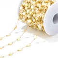 Close-up of 6mm golden bead chain with cream heart shell charms for DIY jewelry making - 1mm Chain 2mm Bead And 6mm Heart / Beige Heart Shell