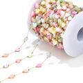 Close-up of 6mm multicolor shell heart beads with gold spacer beads for DIY jewelry - 1mm Chain 2mm Bead And 6mm Heart / Multicolor Heart Shell