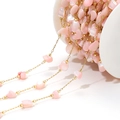 Macro detail of 4mm pink shell petal beads on a gold DIY necklace jewelry chain - 4-7mm Irregular Pink Shell Chain