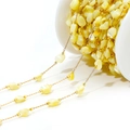 Macro view of 4mm irregular shell beads on a gold chain for DIY jewelry making - 4-7mm Irregular Beige Shell Chain