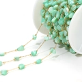 Macro view of 4mm mint green shell beads on golden chain for DIY jewelry making - 4-7mm Irregular Light Green Shell Chain