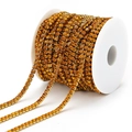 Amber rhinestone claw chain with golden metal base on a white storage spool - Orange