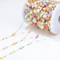 Colorful heart and star bead chain on a spool for DIY jewelry making and necklace crafts - Gold Chain With Large Colorful Star And Heart Shell Beads