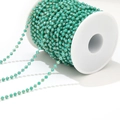 Green crystal beads on golden chain for DIY jewelry making on white spool - Green