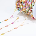 Rainbow star bead chain with golden links on white spool for DIY jewelry making - Gold Chain With Large Colorful Star Shell Beads