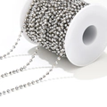 Faceted silver bead chain with gold wire on a white spool for DIY jewelry making - Off-White