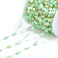 Golden chain with light green shell-textured flower beads on white spool roll - 1mm Gold Chain with 7mm Flower Shell (Green)