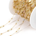 DIY gold chain with iridescent oval crystal beads and golden spacer beads on a spool - Transparent Yellow Multi