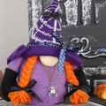 Halloween purple gnome doll with spider decor and orange braids on spooky background - Female Style