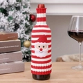 Detail of red and white striped knitted wine bottle cover with a Santa Claus patch ornament - Santa Claus Style