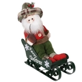 Détail du Père Noël en peluche sur traîneau en métal vert avec texte Merry Christmas - Père Noël