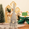 Hanging Christmas gnome ornament with grey plaid hat and long beard on festive background - Gray