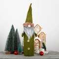 Close-up of green gnome wine bottle cover with long white beard and wooden buttons - Green