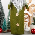 Detail of Christmas gnome wine bottle cover featuring green felt fabric and wooden buttons - Green