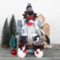 Christmas gnome doll with striped hat and antlers sitting on a blue bench - Gray
