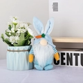 Close-up of a blue Easter bunny gnome with rabbit ears and carrot on a cozy home desk - Sky Blue