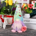 Detailed view of handmade Mother's Day gnome with pastel tie-dye hat and pink flower decoration - Mother's Day Male Style
