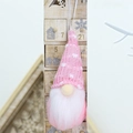 Close-up of pink knitted Christmas gnome ornament with white beard and hanging rope - Pink Polka Dot (Style O)