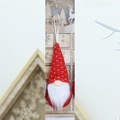 Close-up of a red knitted Christmas gnome ornament hanging against a wooden advent calendar - Solid Red (Style F)