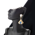 French fan-shaped gold drop earrings with blue gemstones on a black mannequin - Gold Blue Stone Style (ER-881)