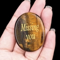 Tiger's eye stone engraved with golden 'Missing you' text held in hand for gift - Tiger's Eye