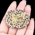 Spotted agate worry stone with Discover your inner self gold engraving on hand - Dalmatian Jasper