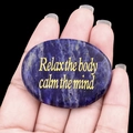Pierre de paume en cristal naturel bleu poli avec texte Relax doré sur fond sombre - Sodalite bleue