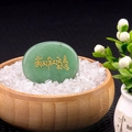 Green palm stone with gold Om Mani Padme Hum mantra in a wooden bowl with white crystals - Green Aventurine