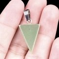 Green aventurine triangle stone pendant with silver clasp held for size reference - Green Aventurine