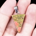 Natural Unakite stone triangle pendant with silver bail shown on palm - Unakite